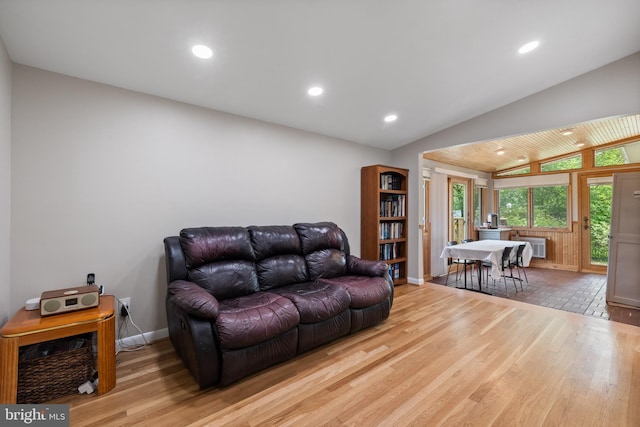 living room featuring wood finished floors, lofted ceiling, recessed lighting, and baseboards