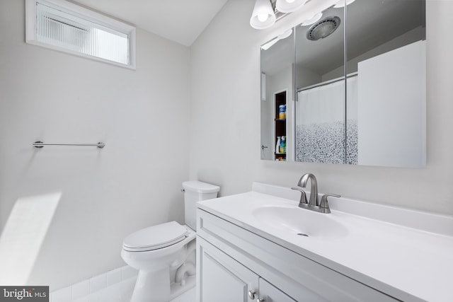 bathroom featuring vanity, toilet, and curtained shower