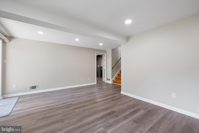 below grade area with stairs, wood finished floors, baseboards, and recessed lighting