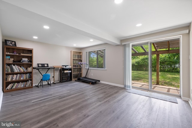 workout room with baseboards, wood finished floors, and recessed lighting