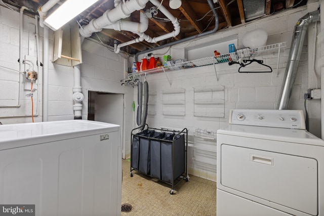 clothes washing area with separate washer and dryer