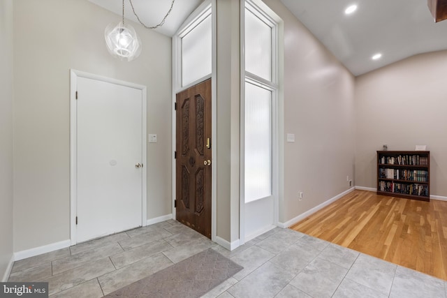 tiled entryway with recessed lighting and baseboards