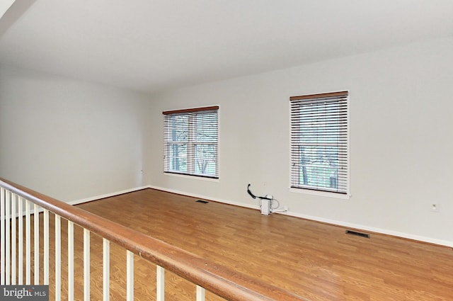 spare room featuring wood finished floors and baseboards