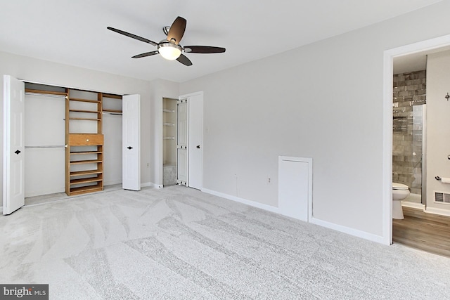 unfurnished bedroom with carpet floors, baseboards, connected bathroom, and a ceiling fan