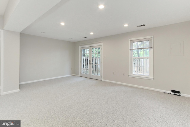 spare room with light colored carpet, baseboards, recessed lighting, and french doors