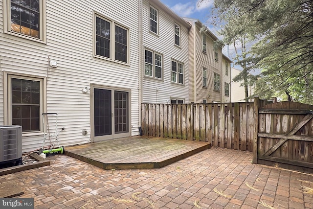 back of house featuring a wooden deck, fence, central AC, and a patio area