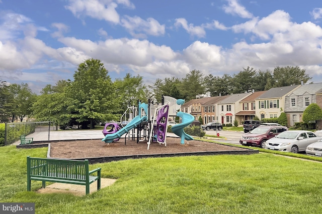 community playground with a lawn and a residential view