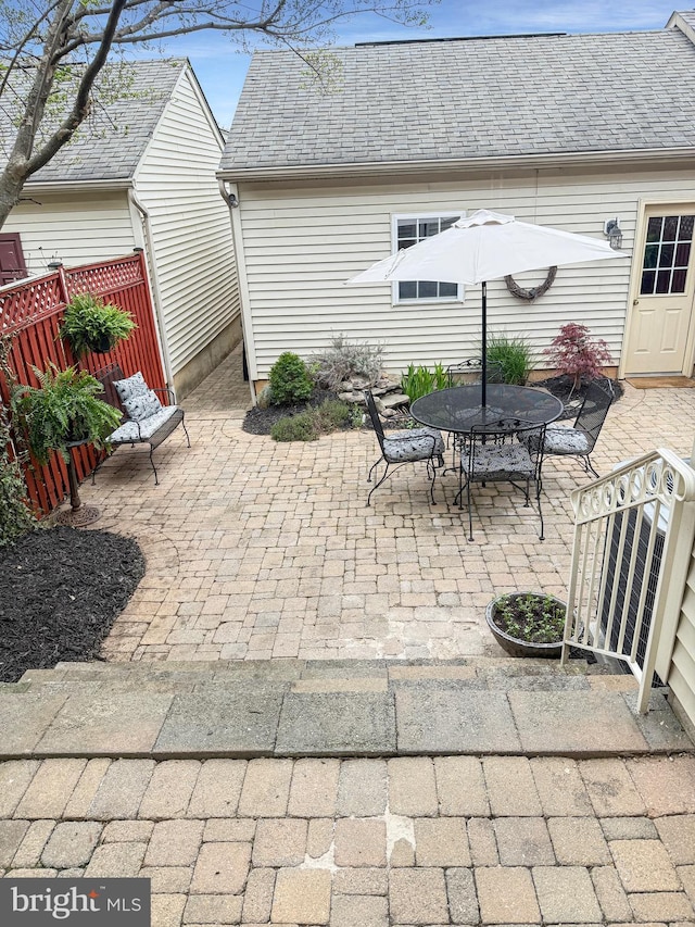 view of patio with fence and outdoor dining space