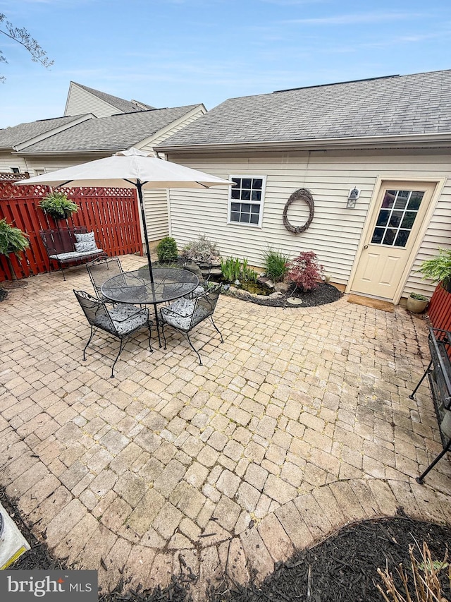 view of patio / terrace featuring fence and outdoor dining area