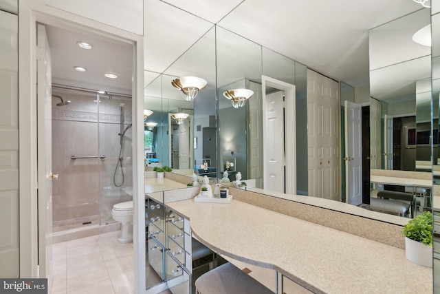 bathroom with a shower stall, toilet, tile patterned flooring, and vanity