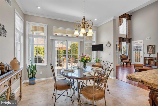 dining space with baseboards, crown molding, and visible vents
