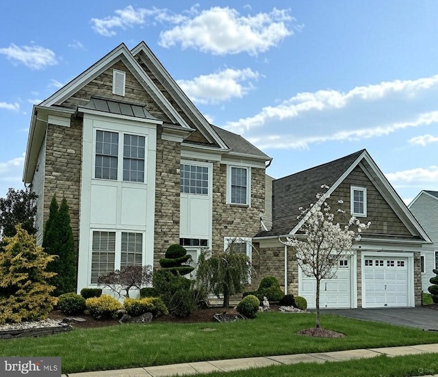 view of front of property with a garage, a front lawn, aphalt driveway, and stone siding