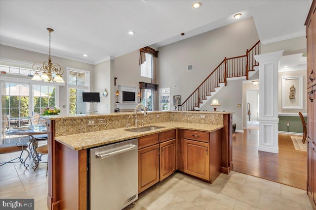 kitchen with pendant lighting, brown cabinets, dishwasher, a sink, and light tile patterned flooring