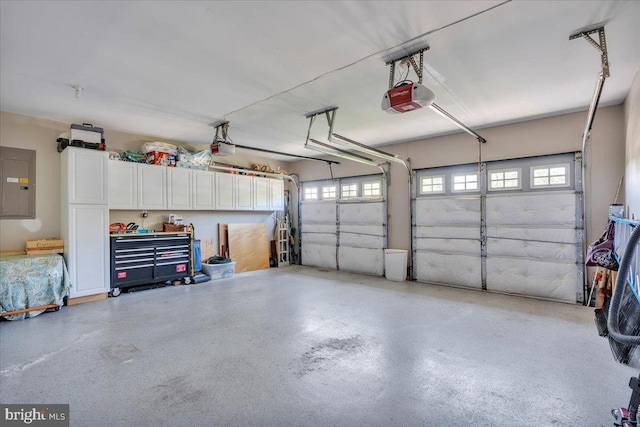 garage with a garage door opener and electric panel
