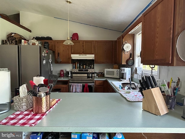 kitchen featuring appliances with stainless steel finishes, light countertops, ventilation hood, vaulted ceiling, and brown cabinetry