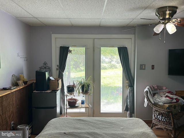 bedroom featuring a paneled ceiling, ceiling fan, access to outside, and freestanding refrigerator