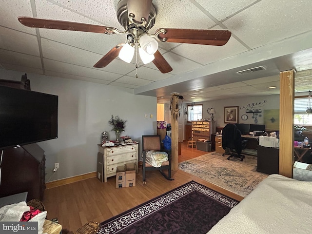 bedroom featuring a paneled ceiling, visible vents, wood finished floors, and baseboards