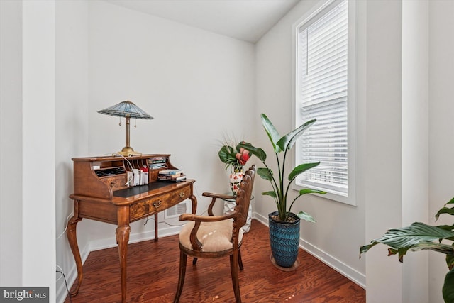 home office with wood finished floors, a healthy amount of sunlight, and baseboards