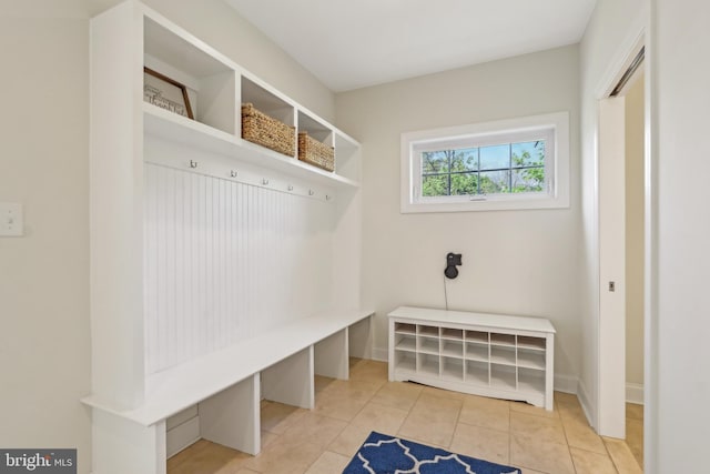 mudroom with tile patterned floors and baseboards