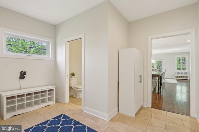 interior space featuring tile patterned floors and baseboards