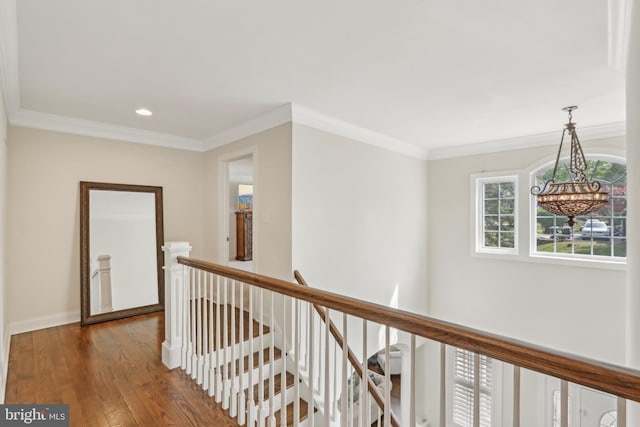 hallway featuring recessed lighting, an upstairs landing, dark wood-style flooring, a notable chandelier, and crown molding