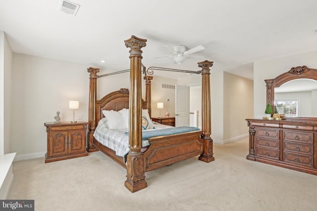 bedroom with visible vents, light carpet, and baseboards