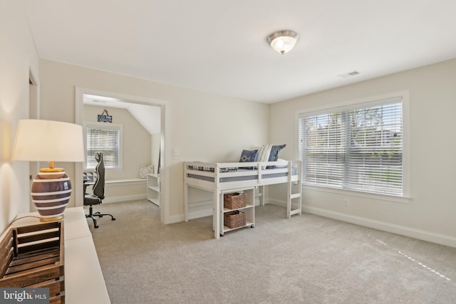 carpeted bedroom featuring baseboards and visible vents