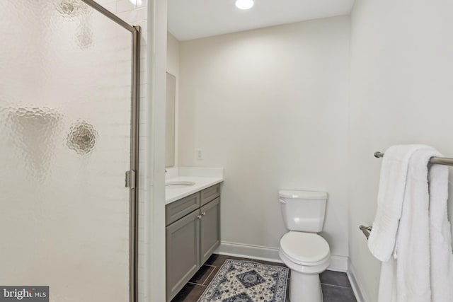 full bathroom featuring a stall shower, baseboards, toilet, tile patterned floors, and vanity