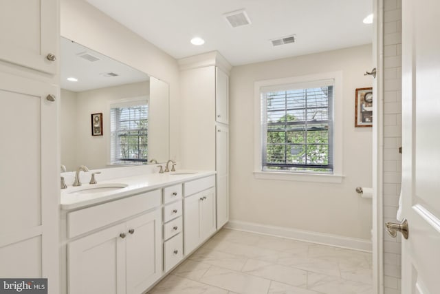 bathroom featuring plenty of natural light, a sink, and visible vents