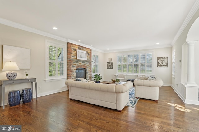 living area featuring plenty of natural light, dark wood-style floors, and decorative columns
