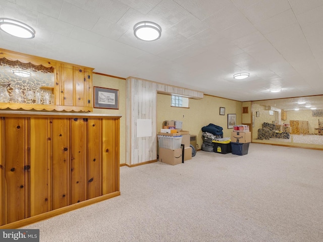 below grade area featuring carpet flooring and baseboards