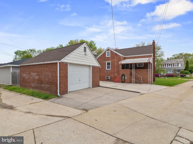 detached garage with concrete driveway