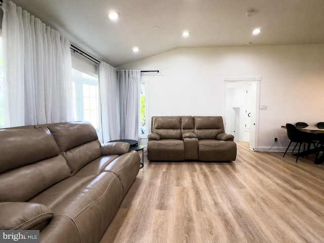 living area featuring recessed lighting, baseboards, vaulted ceiling, and light wood-type flooring