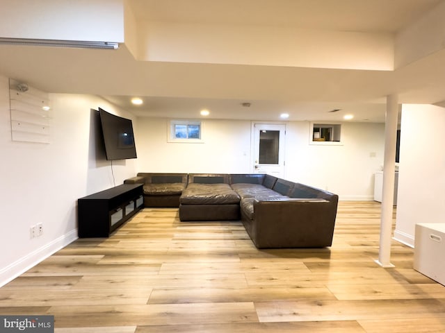 living room featuring recessed lighting, baseboards, and light wood-type flooring