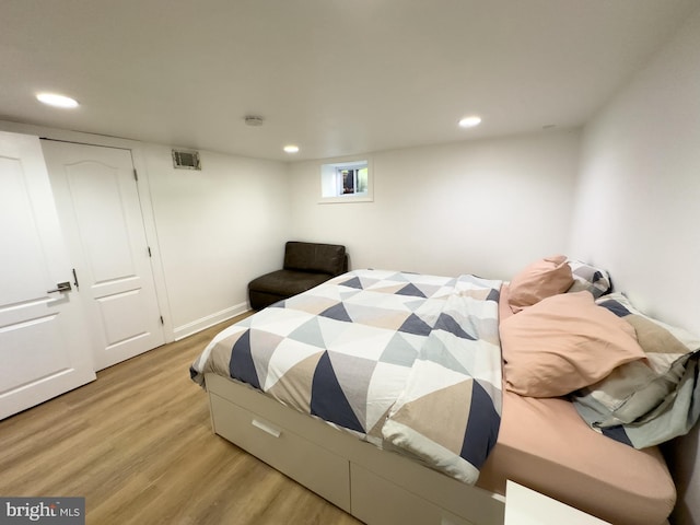 bedroom with recessed lighting, wood finished floors, and visible vents