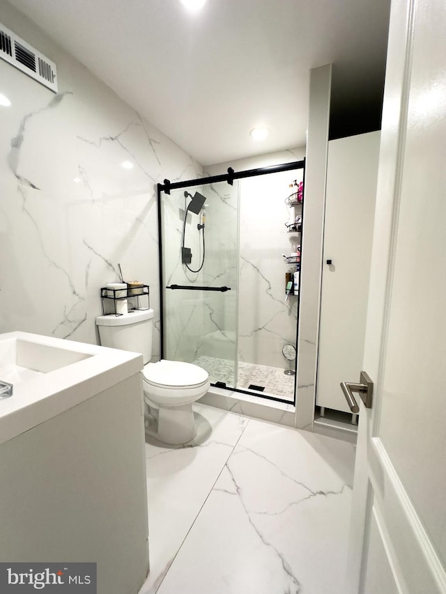 bathroom featuring visible vents, vanity, toilet, marble finish floor, and a marble finish shower