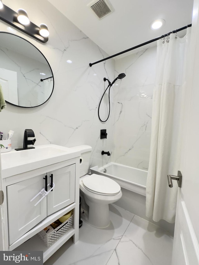 bathroom with shower / bath combo, vanity, marble finish floor, tile walls, and visible vents