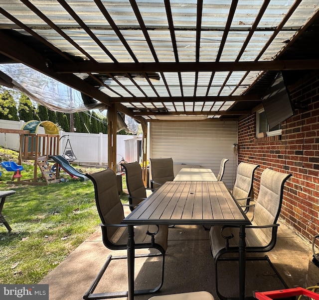 view of patio with a fenced backyard, a playground, a pergola, and outdoor dining space