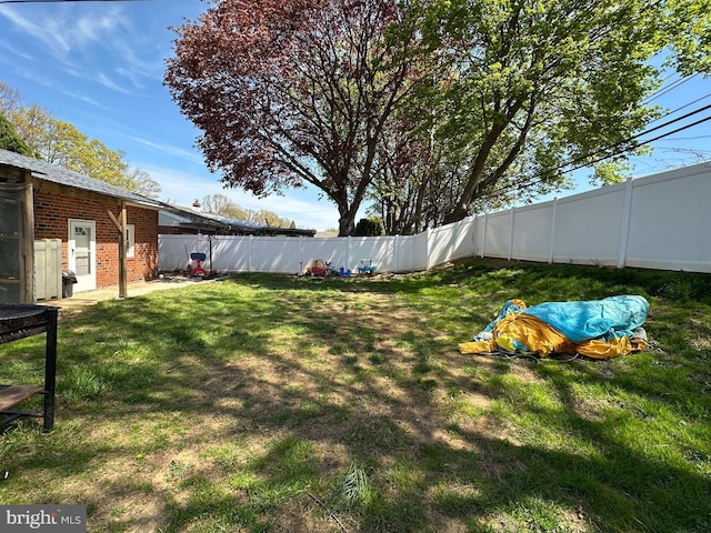 view of yard with a fenced backyard