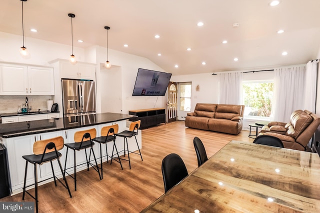 interior space with recessed lighting, vaulted ceiling, and light wood-type flooring