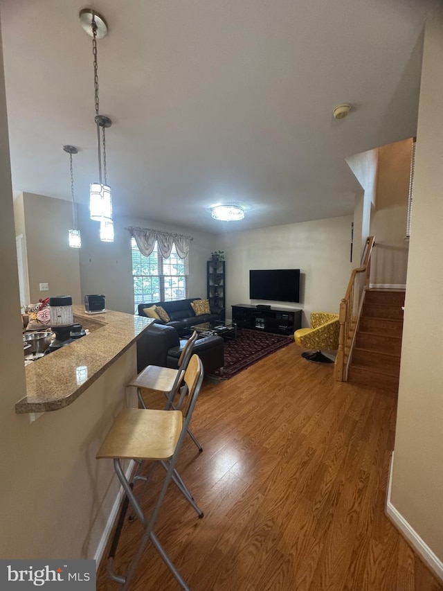 8800 Fenimore Pl, Bristow, VA 20136 - living area featuring wood finished floors, stairway, and baseboards