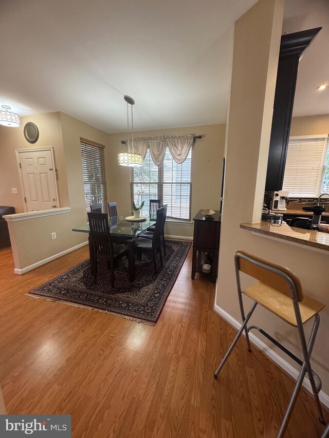8800 Fenimore Pl, Bristow, VA 20136 - dining area featuring wood finished floors, baseboards, and healthy amount of natural light