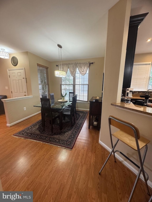 8800 Fenimore Pl, Bristow, VA 20136 - dining area featuring wood finished floors, baseboards, and healthy amount of natural light