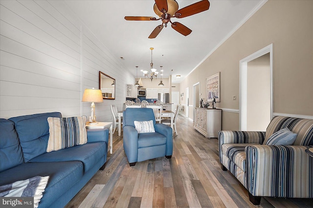 201 S Heron Dr Unit 9B, Ocean City, MD 21842 - living room featuring ornamental molding, ceiling fan with notable chandelier, and hardwood / wood-style floors