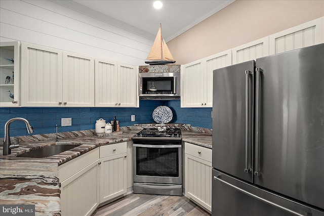 201 S Heron Dr Unit 9B, Ocean City, MD 21842 - kitchen featuring a sink, appliances with stainless steel finishes, ornamental molding, and backsplash
