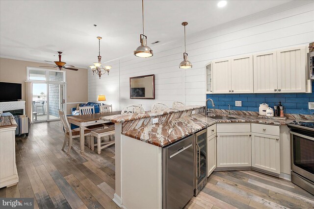 201 S Heron Dr Unit 9B, Ocean City, MD 21842 - kitchen featuring a sink, wood-type flooring, beverage cooler, stainless steel appliances, and a peninsula