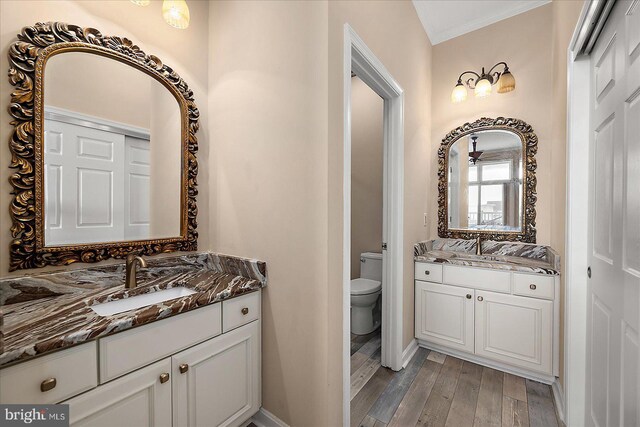201 S Heron Dr Unit 9B, Ocean City, MD 21842 - full bath featuring a sink, toilet, baseboards, two vanities, and wood finished floors