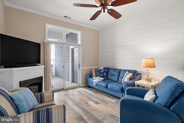 201 S Heron Dr Unit 9B, Ocean City, MD 21842 - living area with visible vents, ornamental molding, wood finished floors, a fireplace, and a ceiling fan