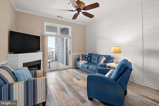 201 S Heron Dr Unit 9B, Ocean City, MD 21842 - living room with ornamental molding, a ceiling fan, hardwood / wood-style flooring, and a fireplace