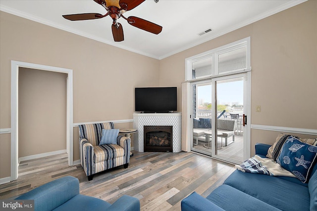 201 S Heron Dr Unit 9B, Ocean City, MD 21842 - living area with a ceiling fan, visible vents, crown molding, a tile fireplace, and wood finished floors